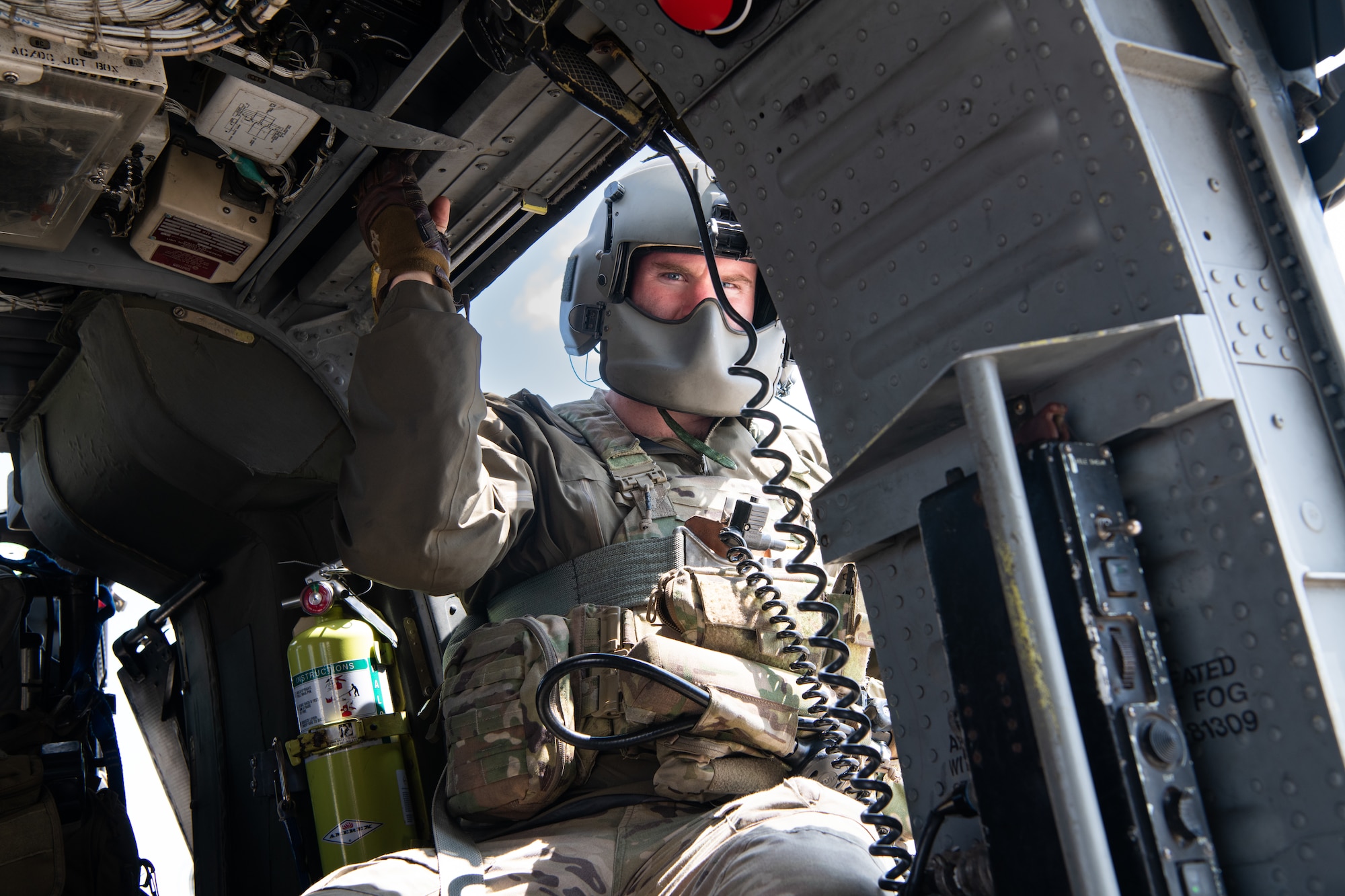 An Airman looks at a camera while waiting to takeoff.