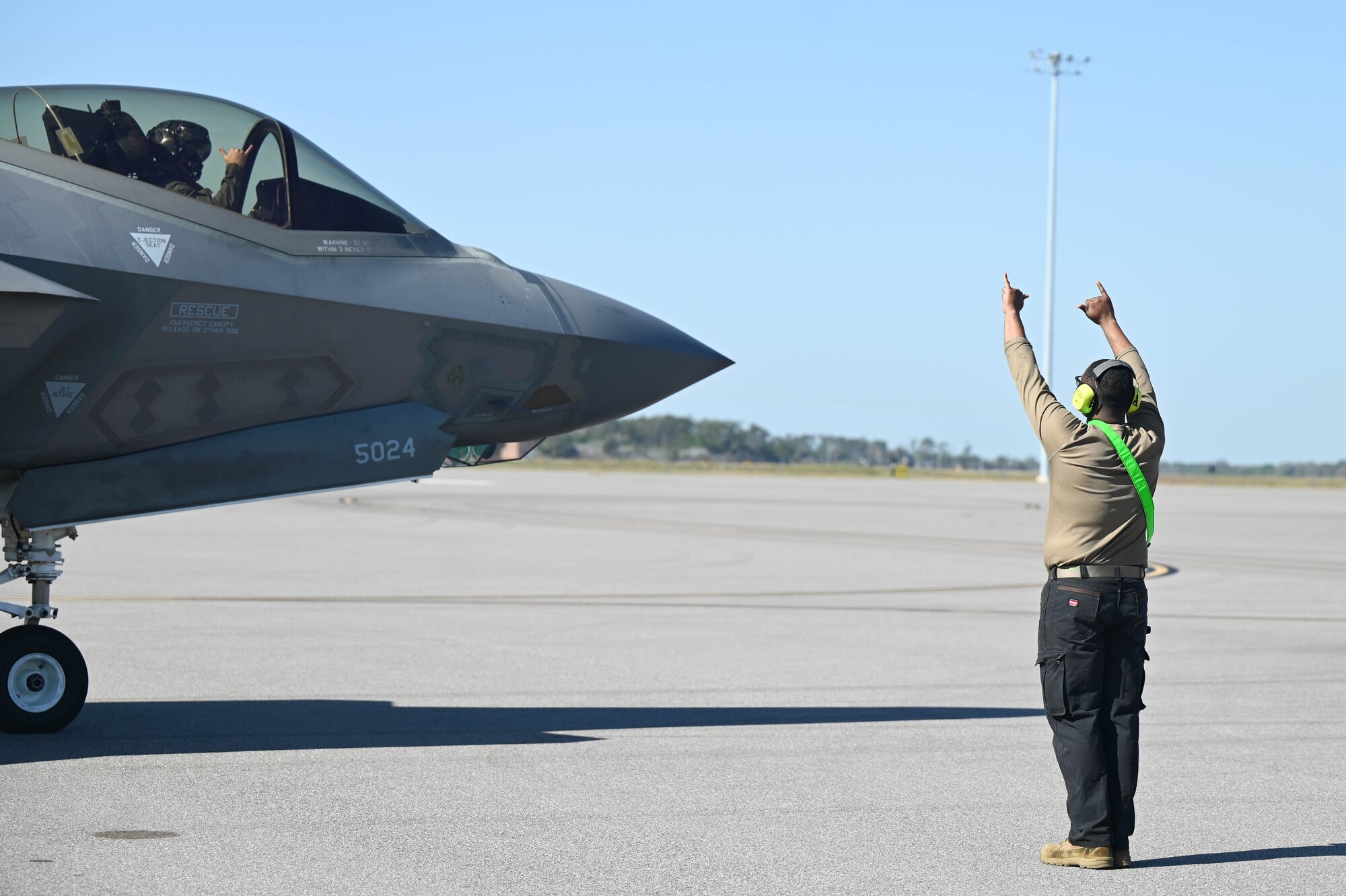 A photo of an Airman and F-35.