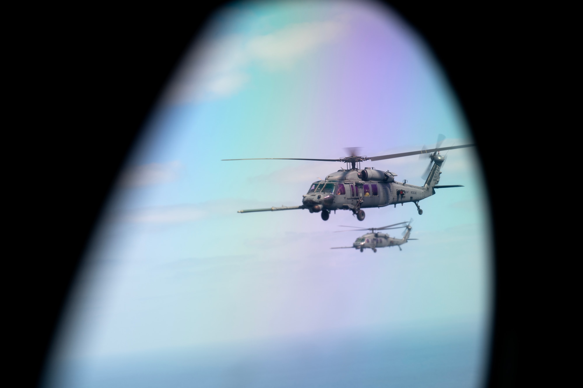 U.S. Air Force HH-60G Pave Hawks assigned to the 33rd Rescue Squadron fly alongside a U.S. Marine Corps KC-130J Super Hercules assigned to Marine Aerial Refueler Transport Squadron (VMGR) 152 during a joint search and rescue training mission over the Pacific Ocean, March 13, 2024. The 33rd RQS conducts extensive training in various rescue scenarios to ensure readiness for real-world threats, crises and humanitarian disasters. (U.S. Air Force photo by Staff Sgt. Jessi Roth)