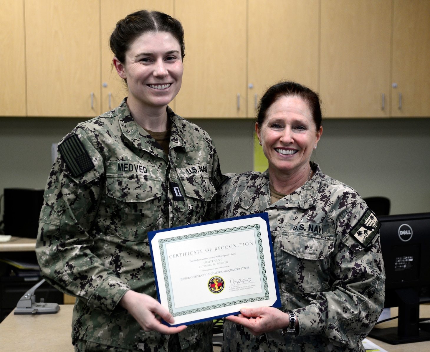 U.S. Navy Capt. Elizabeth Adriano, Navy Medicine Readiness and Training Command's Commander, right, presented Lt. Victoria Medved, left, with a Junior Officer of the Quarter, 4th Quarter, FY2023 certificate during an award presentation at NMRTC San Diego, March 12, 2024. NMRTC San Diego’s mission is to prepare service members to deploy in support of operational forces, deliver high quality healthcare services and shape the future of military medicine through education, training and research. NMRTC San Diego employs more than 6,000 active duty military personnel, civilians and contractors in Southern California to provide patients with world-class care anytime, anywhere. (U.S. Navy photo by Mass Communication Specialist 2nd Class Celia Martin)