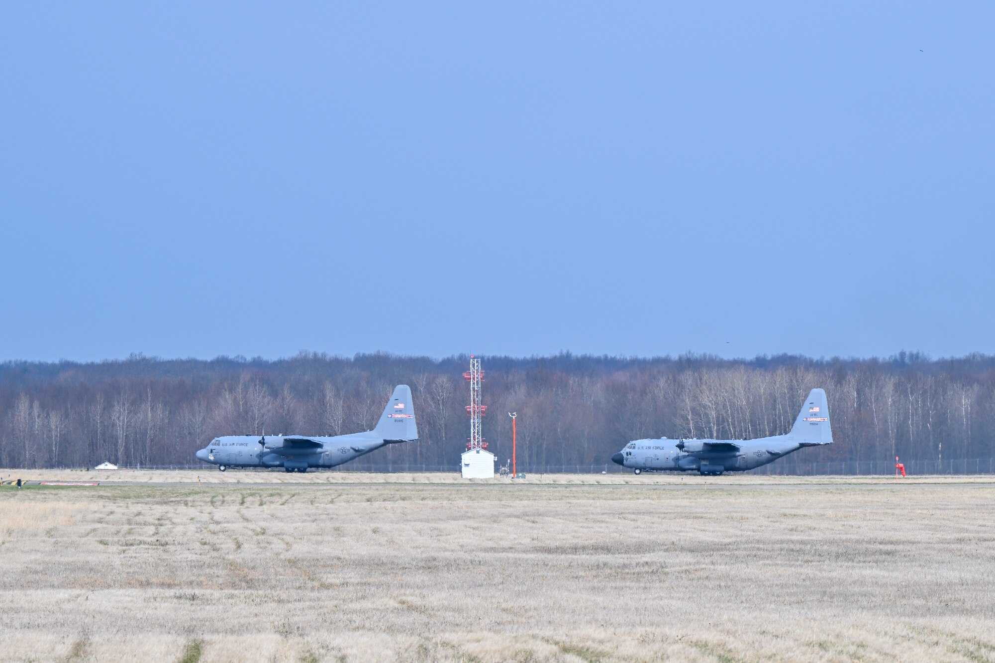 A pair of C-130H Hercules aircraft assigned to the 910th Airlift Wing awaits FAA clearance to approach the runway as they depart Youngstown Air Reserve Station, Ohio, for a local training flight, March 14, 2024.