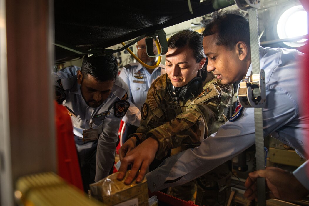 U.S. Air Force Tech. Sgt. Krista McGraw, 18th Aeromedical Evacuation Squadron noncommissioned officer in charge of mission scheduling, showcases a medical supply kit to Bangladesh air force medics