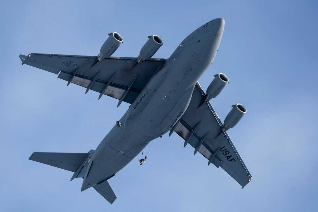 A C-17 Globemaster III assigned to the 176th Wing, Alaska Air National Guard, flies over the Malemute Drop Zone