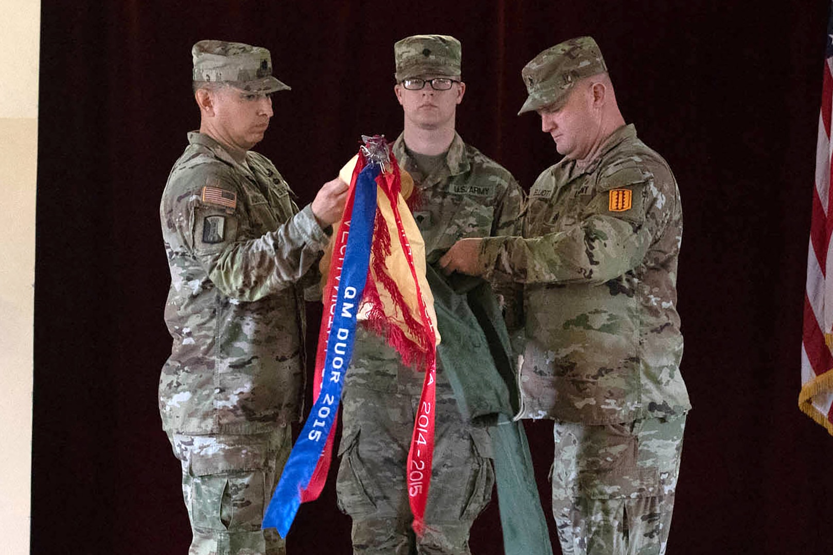 U.S. Army Reserve Lt. Col. Carlos Maldonado, the commander of the 529th Combat Sustainment Support Battalion, and Command Sgt. Maj. David Elliot, the battalion's senior enlisted advisor, uncase their unit colors during a transfer of authority ceremony in Powidz, Poland, March 11, 2024.