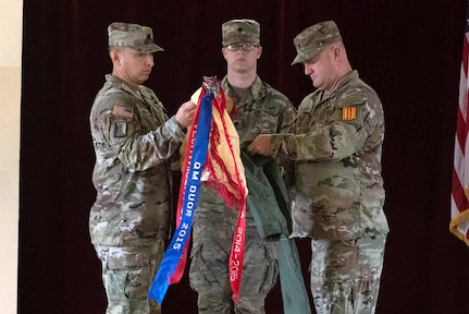 U.S. Army Reserve Lt. Col. Carlos Maldonado, the commander of the 529th Combat Sustainment Support Battalion, and Command Sgt. Maj. David Elliot, the battalion's senior enlisted advisor, uncase their unit colors during a transfer of authority ceremony in Powidz, Poland, March 11, 2024.