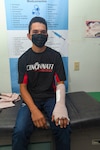 Reynaldo Muñoz, a 19-year-old Honduran resident, poses for a photo in the trauma bay of Hospital Nacional Mario Catarino Rivas after a successful operation  on Feb. 27, 2024. Muñoz was injured in an accident, but regained motion in his left index finger after two surgeons with Expeditionary Medical Unit (EMU) 10 G-Rotation 16 provided trauma care during a Global Health Engagement (GHE). EMU 10 G conducted its first GHE to enhance expeditionary core skills and knowledge exchange with Honduran healthcare professionals in a limited resource environment, Feb. 17 – March 2, 2024.