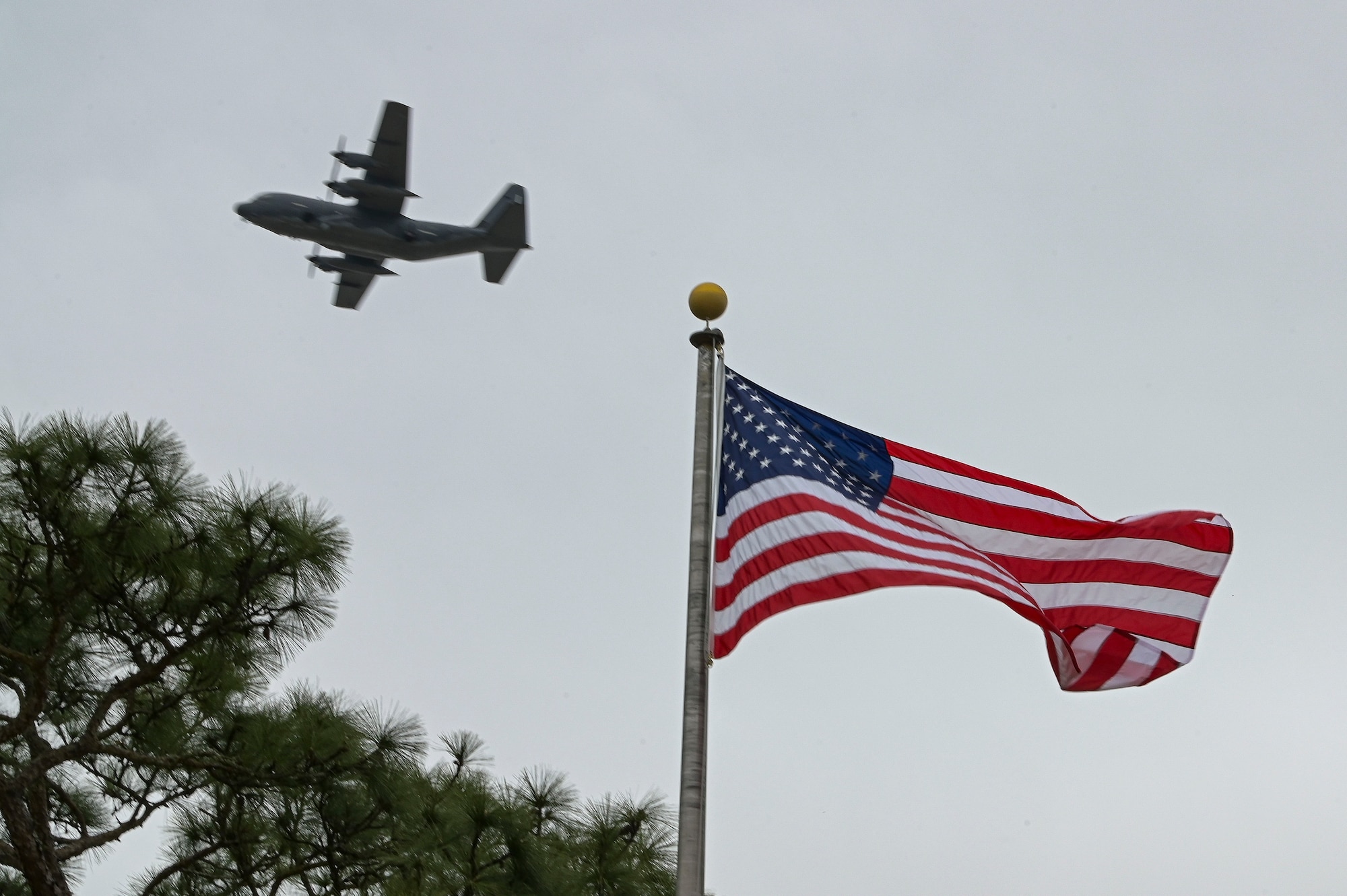 An AC-130J Ghostrider gunship assigned to the 16th Special Operations Squadron flies over the Air Park during the Jockey-14 Remembrance Ceremony at Hurlburt Field, Florida, Mar. 14, 2024.
