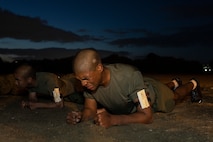 U.S. Marine Corps Recruit Conner Kendrick, with Golf Company, 2nd Recruit Training Battalion, holds a plank position as part of the Marine Corps Physical Fitness Test at Marine Corps Recruit Depot San Diego, California, March 11, 2024. The PFT is conducted during recruit training as an evaluation of stamina and physical conditioning. (U.S. Marine Corps photo by Sgt. Yvonna Guyette)