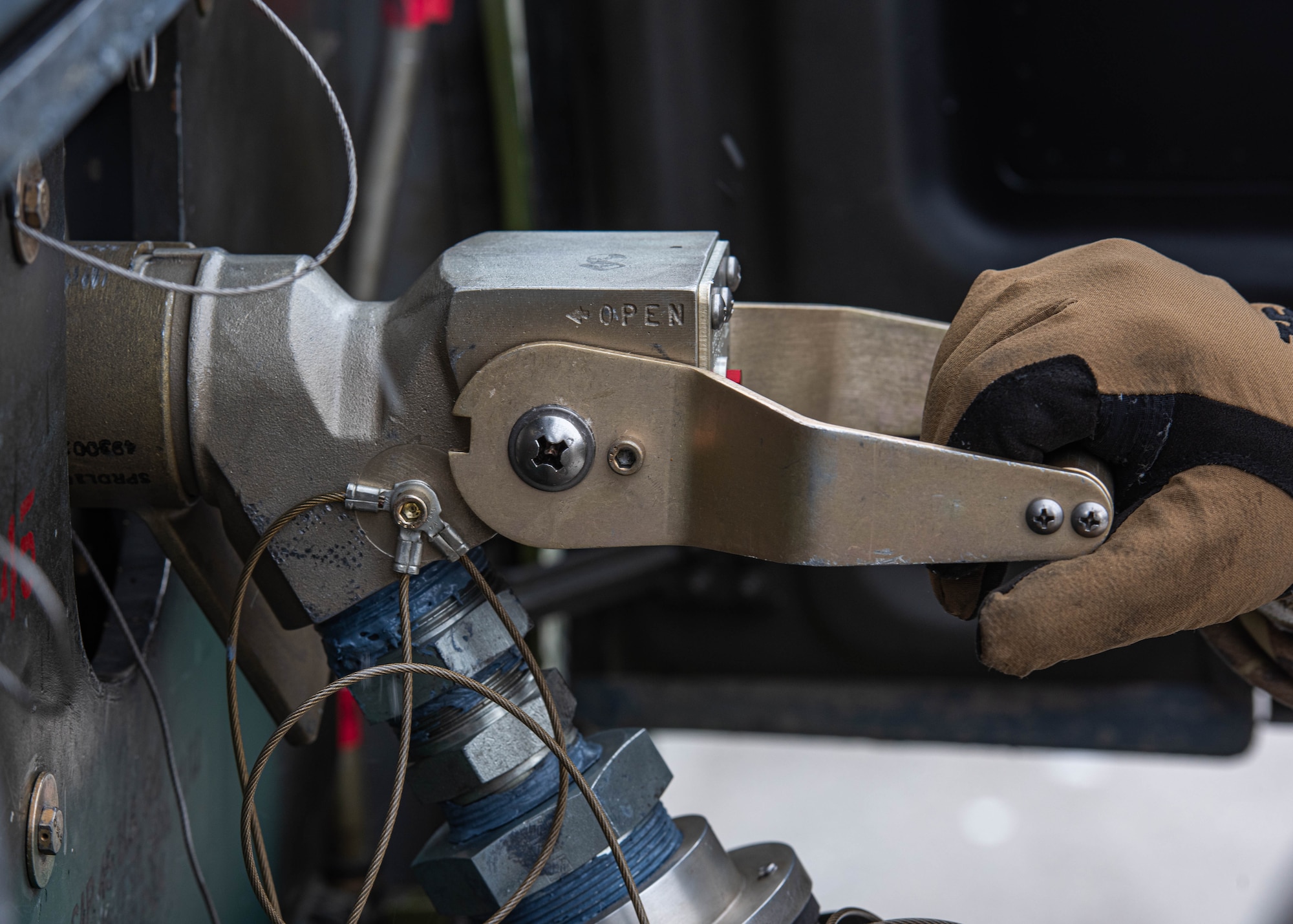 U.S. Air Force Staff Sgt. Michael Norris, 54th Helicopter Squadron (54th HS) evaluator flight engineer, clutches the handle of a fuel hose nozzle at Minot Air Force Base, North Dakota, March 7, 2024. Norris refueled a UH-1N Iroquois assigned to the 54th HS to ensure it can rapidly respond to any situation. (U.S. Air Force photo by Airman 1st Class Kyle Wilson)