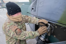 U.S. Air Force Staff Sgt. Michael Norris, 54th Helicopter Squadron evaluator flight engineer, refuels a UH-1N Iroquois at Minot Air Force Base, North Dakota, March 7, 2024. The UH-1N has a maximum range of 300-plus miles and is a major part of Team Minot’s security capabilities. (U.S. Air Force photo by Airman 1st Class Kyle Wilson)
