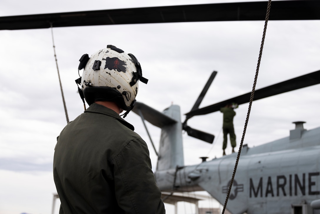 U.S. Marine Corps Staff Sgt. Joseph McDonnell, a CH-53E Super Stallion crew chief with Marine Heavy Helicopter Squadron (HMH) 462, Marine Aircraft Group 16, 3rd Marine Aircraft Wing, conducts post-flight maintenance on a CH-53E Super Stallion helicopter at Lake Havasu City, Arizona, Feb. 26, 2024. HMH-462 conducted unit deployment training to increase combat effectiveness, build flight leadership, and enhance aircrew proficiency. (U.S. Marine Corps photo by Lance Cpl. Jackson Rush)