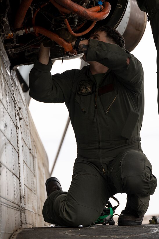 U.S. Marine Corps Staff Sgt. Joseph McDonnell, a CH-53E Super Stallion crew chief with Marine Heavy Helicopter Squadron (HMH) 462, Marine Aircraft Group 16, 3rd Marine Aircraft Wing, conducts post-flight maintenance on a CH-53E Super Stallion helicopter at Lake Havasu City, Arizona, Feb. 26, 2024. HMH-462 conducted unit deployment training to increase combat effectiveness, build flight leadership, and enhance aircrew proficiency. (U.S. Marine Corps photo by Lance Cpl. Jackson Rush)