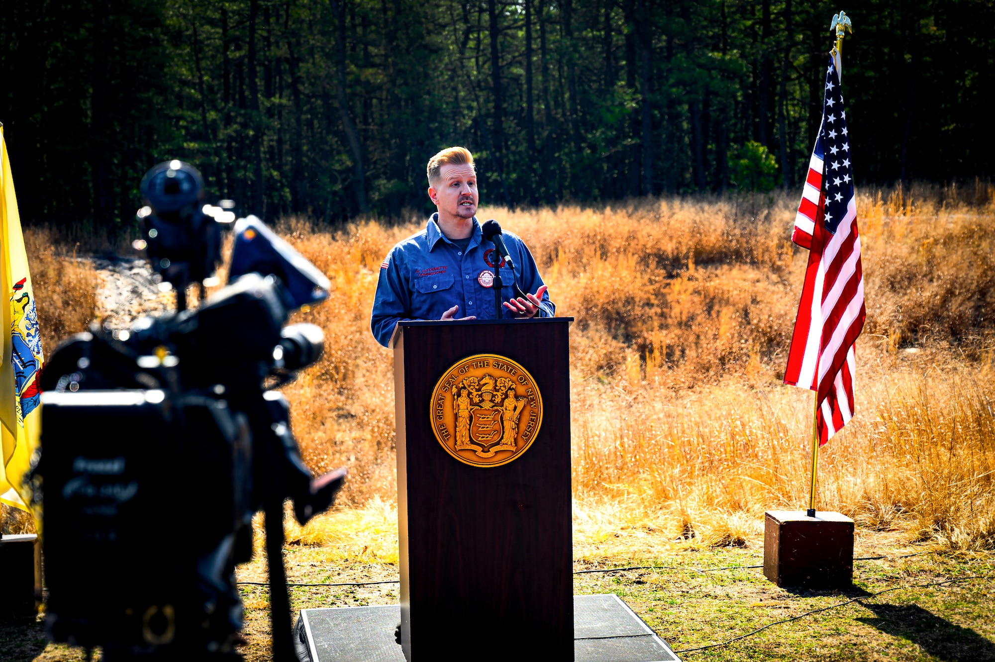 Shawn LaTourette, New Jersey Department of Environmental Protection commissioner, gives opening remarks during a firebreak demonstration in Manchester Township, N.J., March 13, 2024. Officials toured a strategic forest fuel break in Manchester Township, Ocean County, one of three wildfire resilience projects in the Pinelands funded through the U.S. Department of Defense’s Readiness and Environmental Protection Integration Challenge Program. REPI facilitates long-term partnerships to improve resilience to climate change, preserve wildlife habitats and natural resources, and promote sustainable land uses near military installations and ranges. (U.S. Air Force photo by Senior Airman Matt Porter)