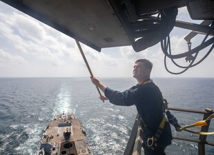 A Sailor conducts weather preservation aboard USS Gravely (DDG 107) in the Arabian Sea.