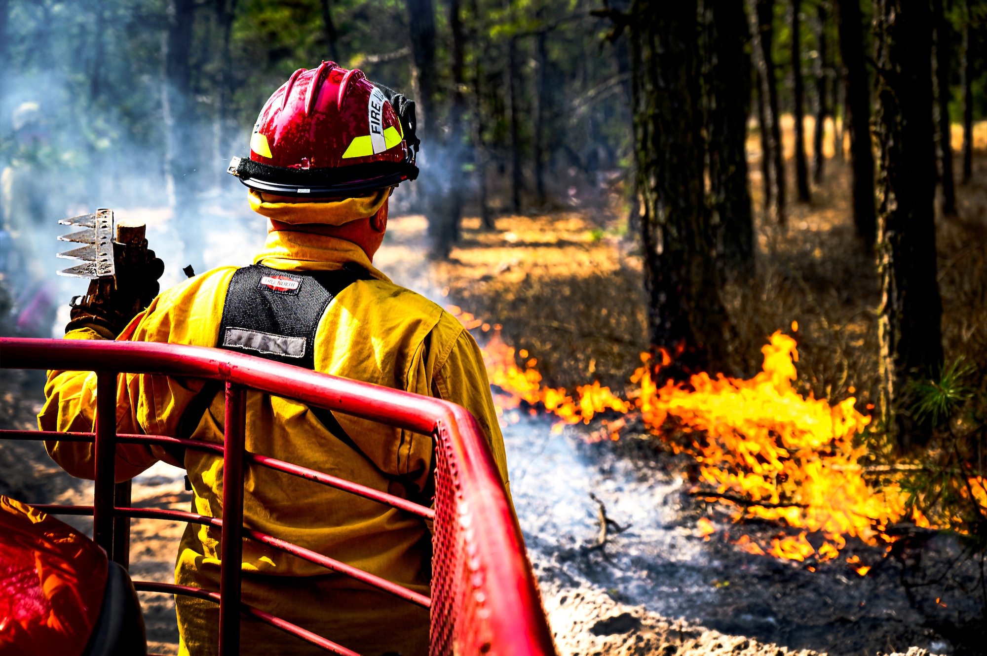 A Firewarden with the New Jersey Forest Fire Service monitors undergrowth during a firebreak demonstration at Manchester Township, N.J. in Manchester Township, N.J., March 13, 2024. Officials toured a strategic forest fuel break in Manchester Township, Ocean County, one of three wildfire resilience projects in the Pinelands funded through the U.S. Department of Defense’s Readiness and Environmental Protection Integration Challenge Program. REPI facilitates long-term partnerships to improve resilience to climate change, preserve wildlife habitats and natural resources, and promote sustainable land uses near military installations and ranges. (U.S. Air Force photo by Senior Airman Matt Porter)