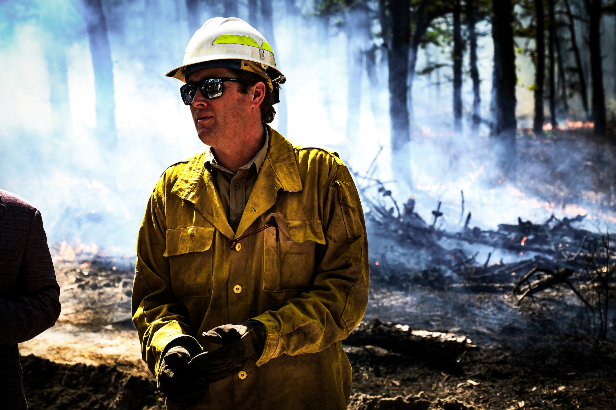 A Firewarden with the New Jersey Forest Fire Service monitors undergrowth during a firebreak demonstration at Manchester Township, N.J. in Manchester Township, N.J., March 13, 2024. Officials toured a strategic forest fuel break in Manchester Township, Ocean County, one of three wildfire resilience projects in the Pinelands funded through the U.S. Department of Defense’s Readiness and Environmental Protection Integration Challenge Program. REPI facilitates long-term partnerships to improve resilience to climate change, preserve wildlife habitats and natural resources, and promote sustainable land uses near military installations and ranges. (U.S. Air Force photo by Senior Airman Matt Porter)