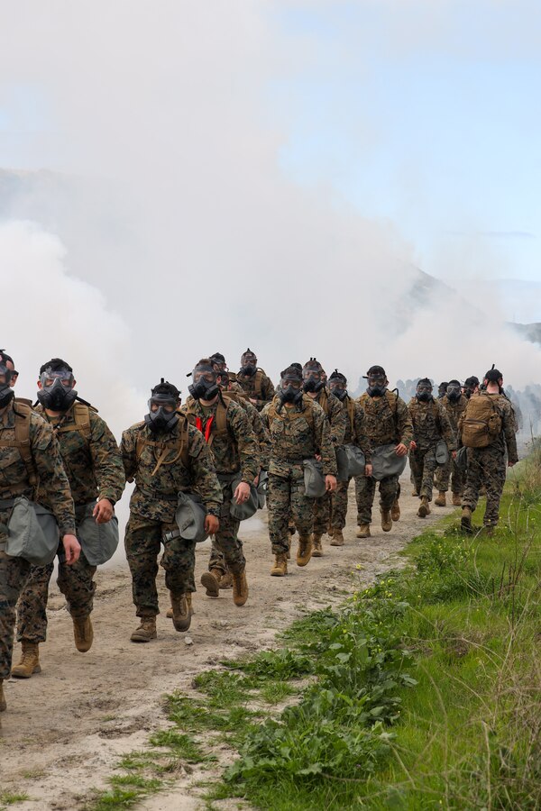 U.S. Marines with Marine Aviation Logistics Squadron 39, Marine Aircraft Group 39, 3rd Marine Aircraft Wing, conduct a chemical, biological, radiological and nuclear training hike at Camp Pendleton, California, March 1, 2024.  MALS-39 conducted the hike to promote squadron comradery while fulfilling annual training requirements and facilitating CBRN protective procedures and readiness. (U.S. Marine Corps photo by Lance Cpl. Nicholas Johnson)