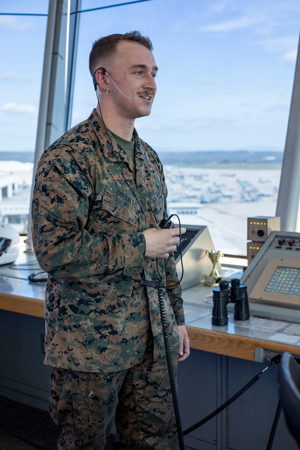 U.S. Marine Corps Cpl. Connor Dohony, an air traffic controller with Headquarters and Headquarters Squadron, Marine Corps Air Station Miramar, conducts daily operations in the air traffic control tower at MCAS Miramar, California, March 5, 2024. Air traffic controllers coordinate with pilots to maintain and oversee the safe, orderly, and expeditious flow of air traffic operations in control zones, expeditionary airfields, or remote area landing sites. (U.S. Marine Corps photo by Sgt. Sean Potter)