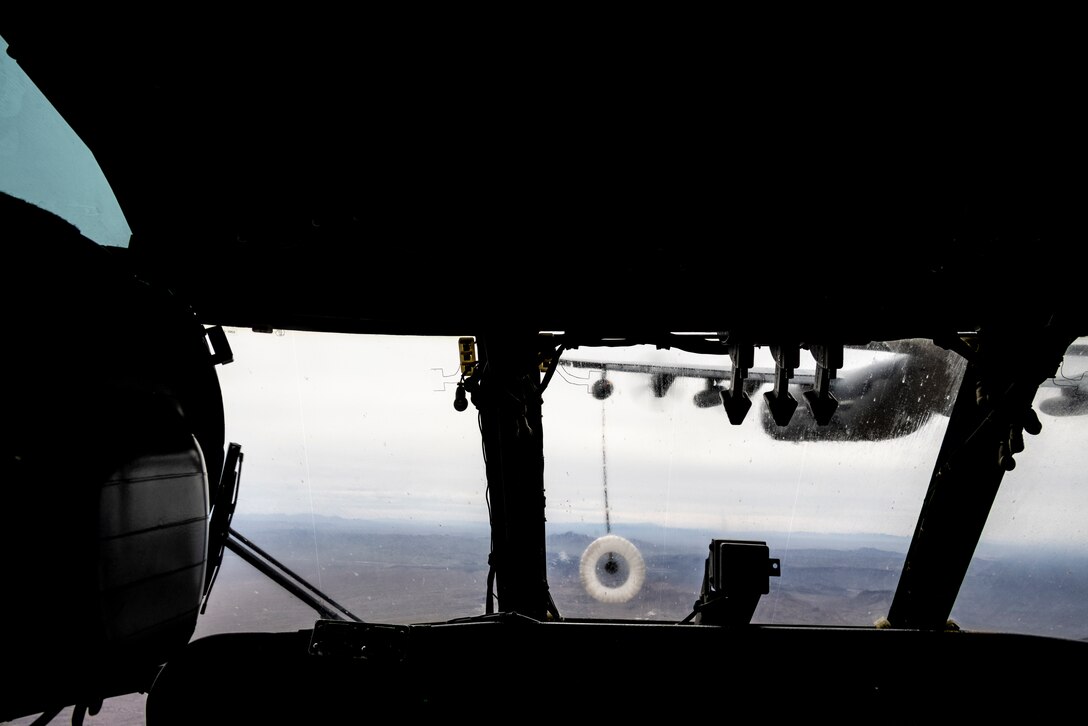 U.S. Marine Corps Capt. Frank Davis, a CH-53E Super Stallion helicopter pilot with Marine Heavy Helicopter Squadron (HMH) 462, Marine Aircraft Group 16, 3rd Marine Aircraft Wing, maneuvers a CH-53E Super Stallion to connect the helicopter’s refueling probe with the drogue of a U.S. Air Force HC-130J Combat King II assigned to the 79th Rescue Squadron, 563rd Rescue Group, 355th Rescue Wing, during joint air-to-air refueling near Lake Havasu City, Arizona, Feb. 26, 2024. The “Heavy Haulers” of HMH-462 conducted air-to-air refueling during unit deployment training to enhance aircrew proficiency and increase combat effectiveness. (U.S. Marine Corps photo by Lance Cpl. Jackson Rush)