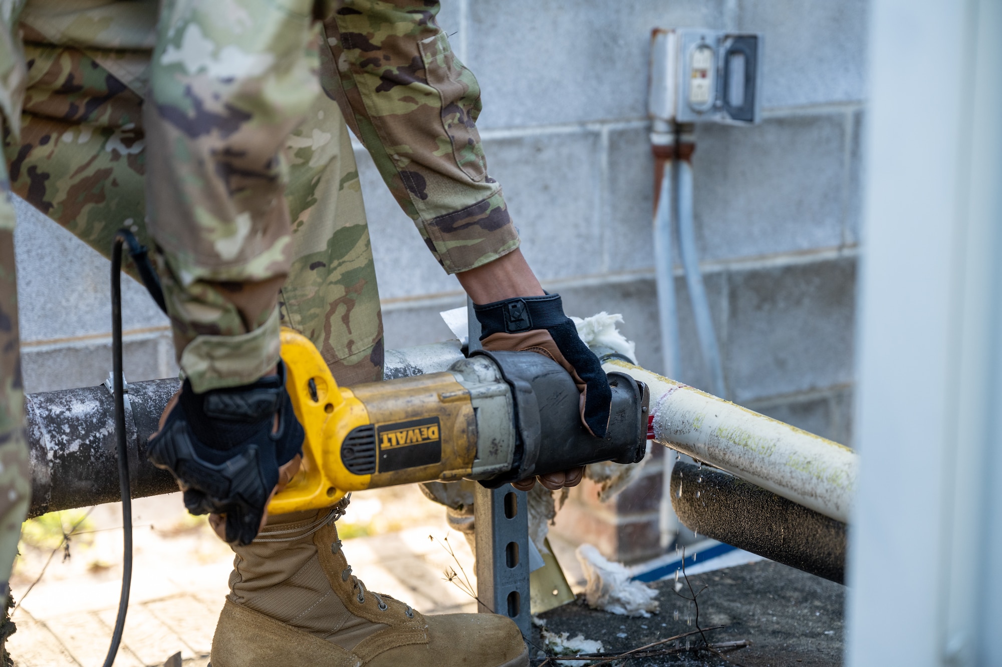 A U.S. Air Force Airman from the 1st Special Operations Civil Engineer Squadron Heating, Ventilation and Air Conditioning shop, saws a pipe while replacing a chiller at Hurlburt Field, Florida, March 13, 2024. Replacing the chiller provides the Chapel with a more reliable air conditioning system to ensure Air Commandos and families will be comfortable while visiting the Chapel during the summer months. (U.S. Air Force photo by Senior Airman Alysa Calvarese)