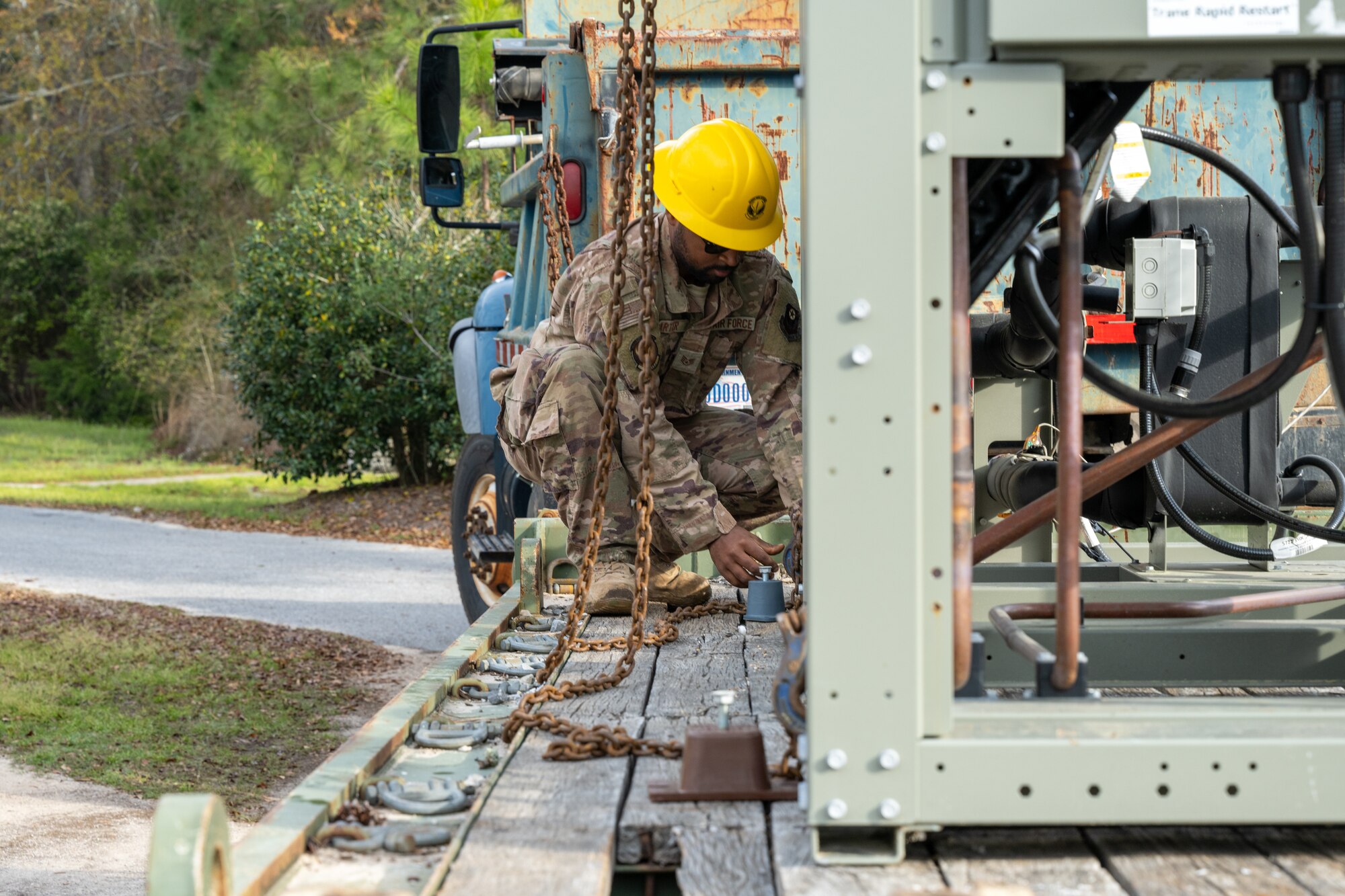 U.S. Air Force Staff Sgt. Alonza Carter, a 1st Special Operations Civil Engineer Squadron pavement and construction equipment craftsman, helps replace a chiller at Hurlburt Field, Florida, March 13, 2024. Replacing the chiller provides the Chapel with a more reliable air conditioning system to ensure Air Commandos and families will be comfortable while visiting the Chapel during the summer months. (U.S. Air Force photo by Senior Airman Alysa Calvarese)