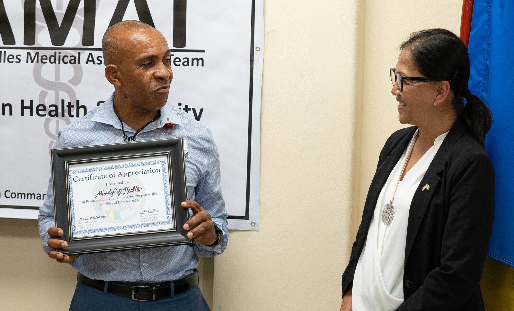 Cuthbert Knights, permanent secretary, Ministry of Health Wellness and the Environment, accepts a certificate of appreciation at the Financial Complex, Kingstown, during the Lesser Antilles Medical Assistance Team mission in St. Vincent and the Grenadines, March 4, 2024. Thirty-four active duty and reserve Airmen participated in this year’s LAMAT mission to St. Vincent and the Grenadines, assisting in health engagements, exchanging best practices and developing stronger relationships with host nation partners. (U.S. Air Force photo by Capt. Danny Rangel)
