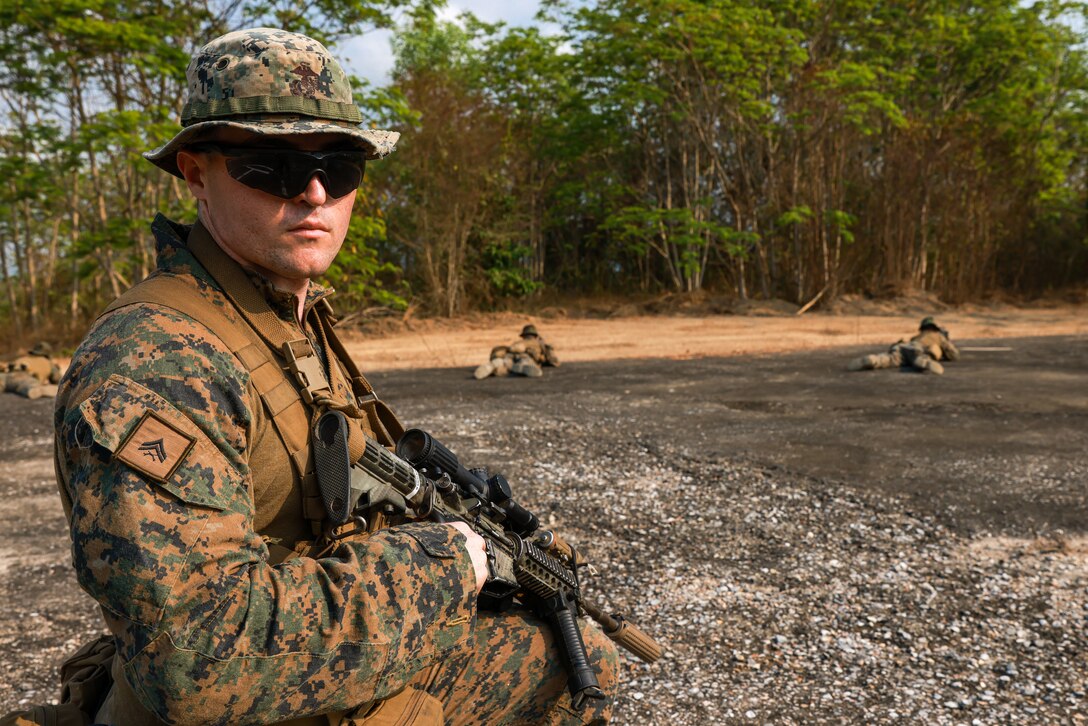 U.S. Marine Corps Cpl. Derek Robertson, a section leader assigned to Light Armored Reconnaissance Company, Battalion Landing Team 1/5, 15th Marine Expeditionary Unit, and a California native, monitors the surrounding area with his squad posting security during jungle tactics training at Exercise Cobra Gold in Chanthaburi province, Thailand, Feb. 29, 2024. Cobra Gold, now in its 43rd year, is a Thai-U.S. co-sponsored training event that builds on the long-standing friendship between the two allied nations and brings together a robust multinational force to promote regional peace and security in support of a free and open Indo-Pacific. (U.S. Marine Corps photo by Cpl. Aidan Hekker)