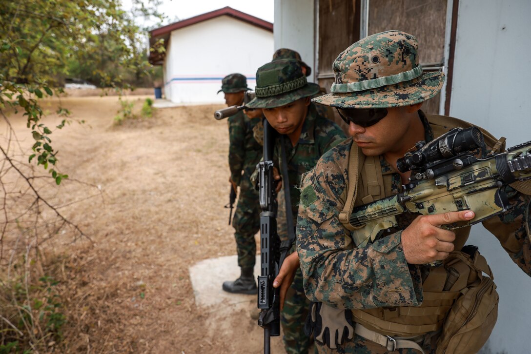 U.S. Marine Corps Lance Cpl. Francisco Izaguirre, front, a mortarman assigned to Charlie Company, Battalion Landing Team 1/5, 15th Marine Expeditionary Unit, prepares to search a building with Royal Thai Marines during military operations on urbanized terrain training as part of Exercise Cobra Gold in Chanthaburi province,  Thailand, Feb. 29, 2024. Cobra Gold, now in its 43rd year, is a Thai-U.S. co-sponsored training event that builds on the long-standing friendship between the two allied nations and brings together a robust multinational force to promote regional peace and security in support of a free and open Indo-Pacific. (U.S. Marine Corps photo by Cpl. Aidan Hekker)