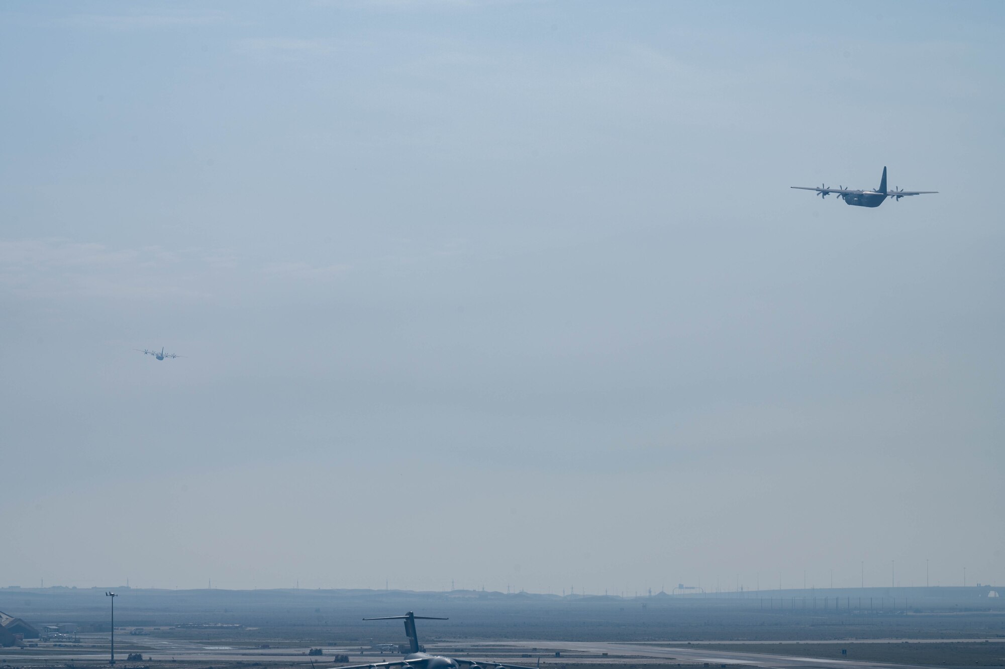 Two C-130J aircraft loaded with humanitarian aid bound for airdrop over Gaza take off.