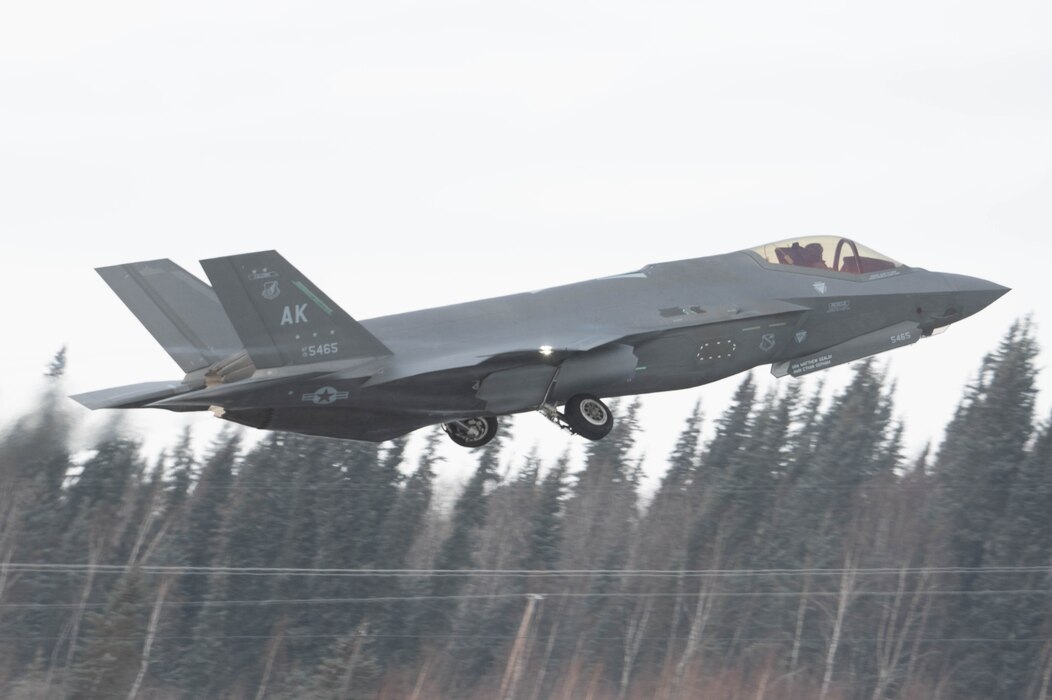 An F-35A Lightning II retracts its wheels as it takes off for a routine training at Eielson Air Force Base, Alaska, March 14, 2024.