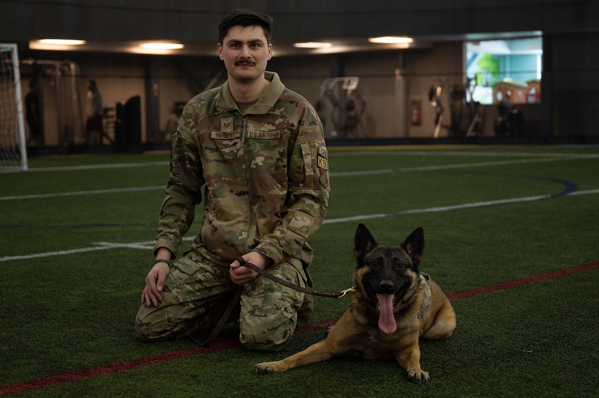 U.S. Air Force Staff Sgt. Alex Petkovic, poses with his military working dog Kefe.