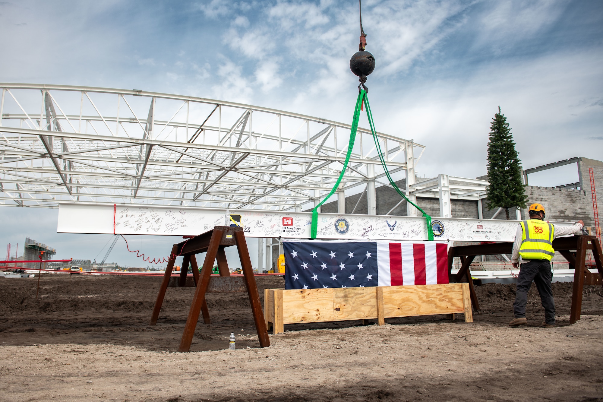 A construction worker signs a support beam.