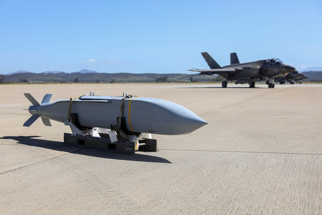 An AGM-154 Joint Standoff Weapon (JSOW) is staged on the flight line before being loaded onto a F-35C Lightning II at Marine Corps Air Station Miramar, California, March 8, 2024. The JSOW is a fire-and-forget medium-range precision guided weapon intended for use against soft targets. This loading of the JSOW is the first loading of the weapon system on the F-35C and the first time being loaded in a garrison environment in nearly 20 years. (U.S. Marine Corps photo by Sgt. Sean Potter)