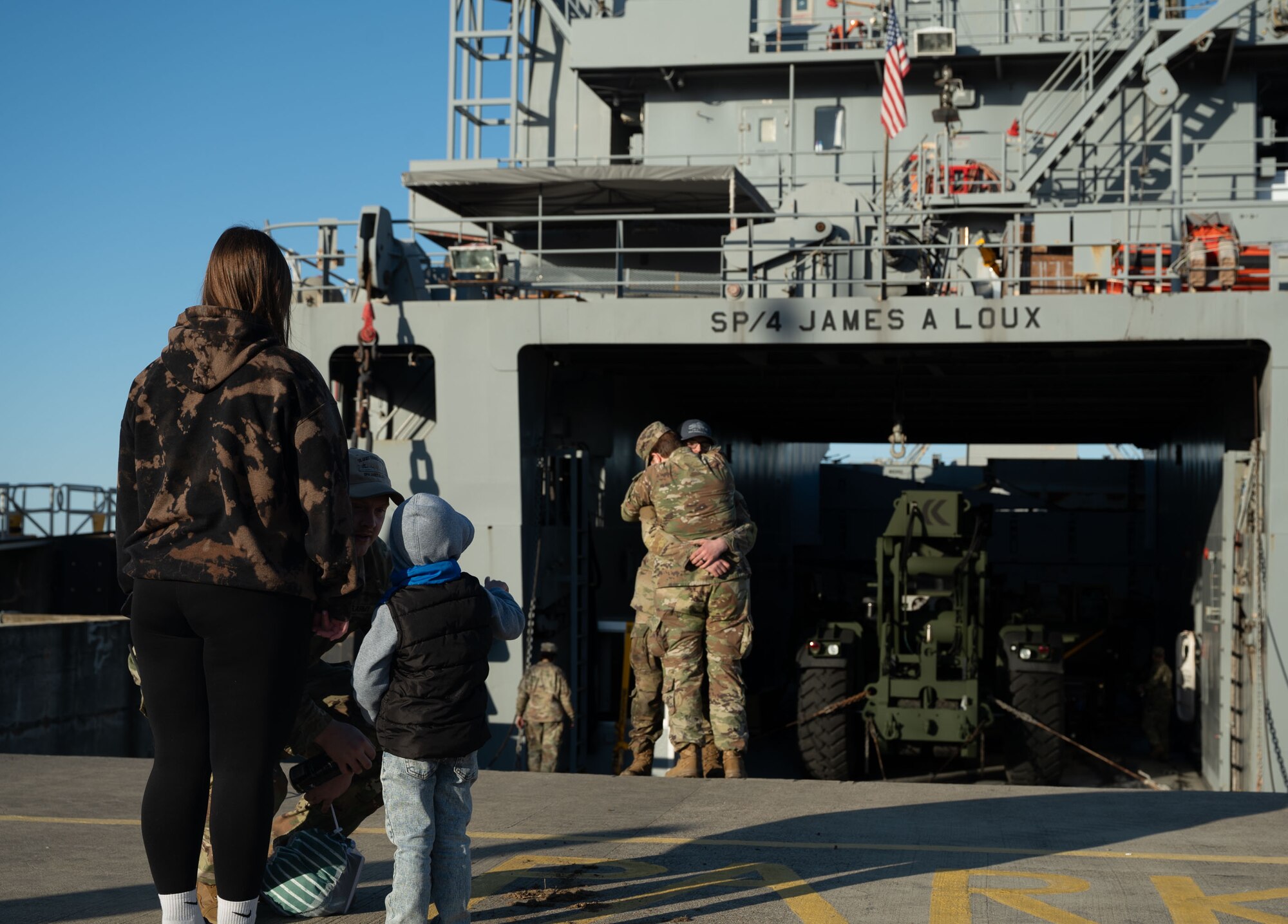 U.S. Army Soldiers bid farewell to family and friends before going underway in their logistics support vessel at Joint Base Langley-Eustis, V.A.