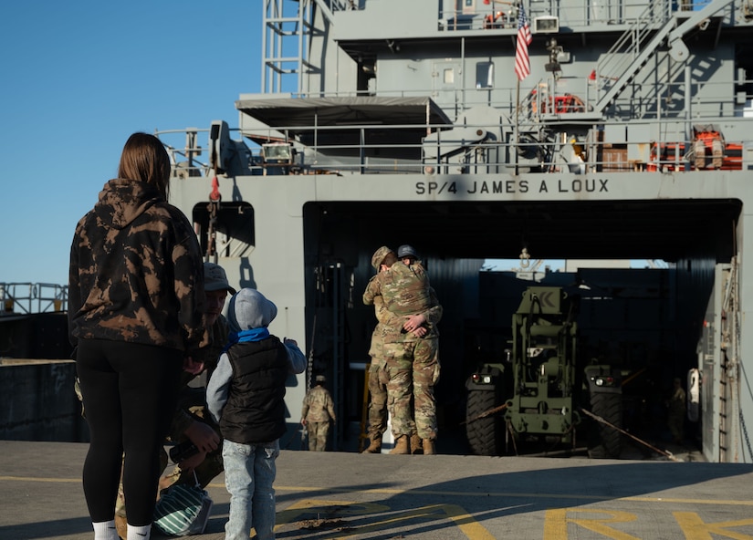 U.S. Army Soldiers from the 7th Transportation Battalion bid farewell to family and friends before going underway in their logistics support vessel at Joint Base Langley-Eustis, V.A., March 12, 2024. The Army mariners shipped out to provide joint logistics over the shore capabilities in Gaza for humanitarian aid efforts. (U.S. Air Force photo by Senior Airman Jack LeGrand)