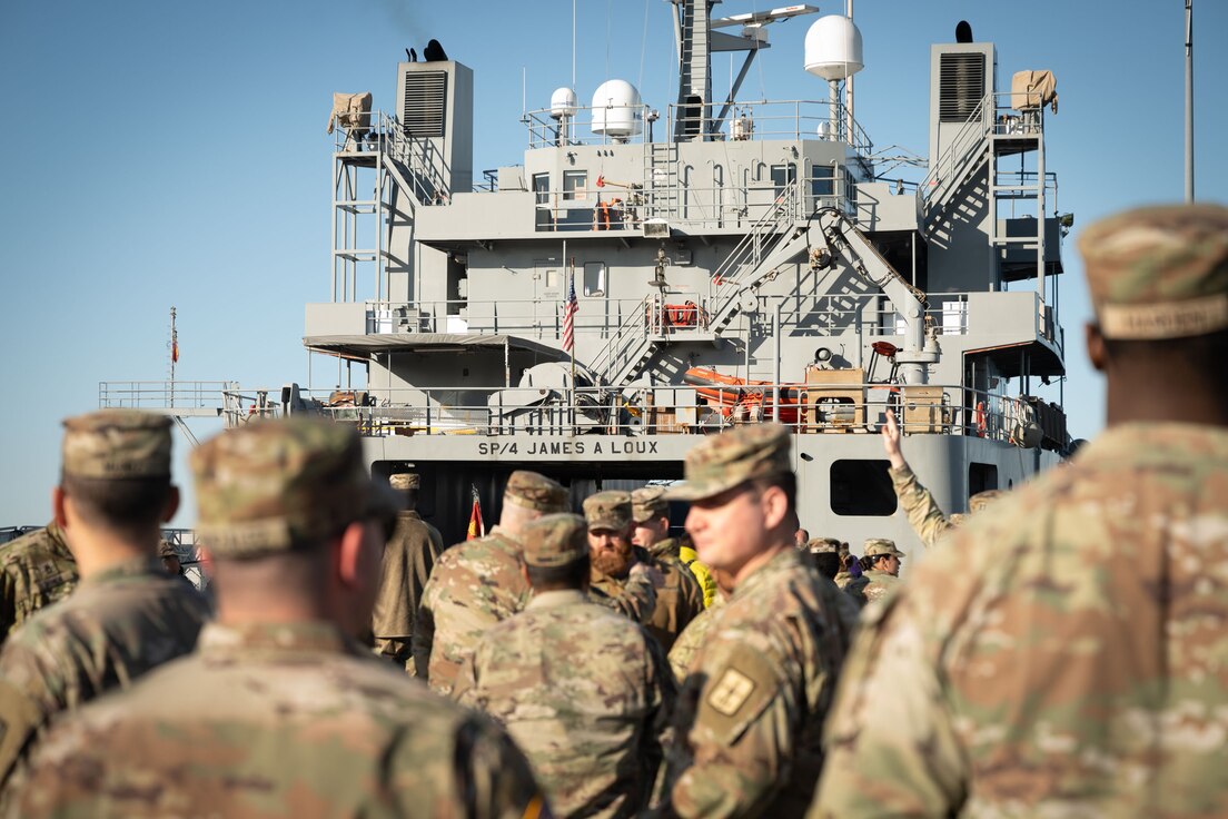 U.S. Army Soldiers from the 7th Transportation Battalion gather to ship out to Gaza to provide joint logistics over the shore capabilities in support of humanitarian aid to Gaza at Joint Base Langley-Eustis, V.A., March 12, 2024. The Army mariner’s logistics support vessel can carry and deploy supplies without going ashore through its Trident Pier system. (U.S. Air Force photo by Senior Airman Jack LeGrand)