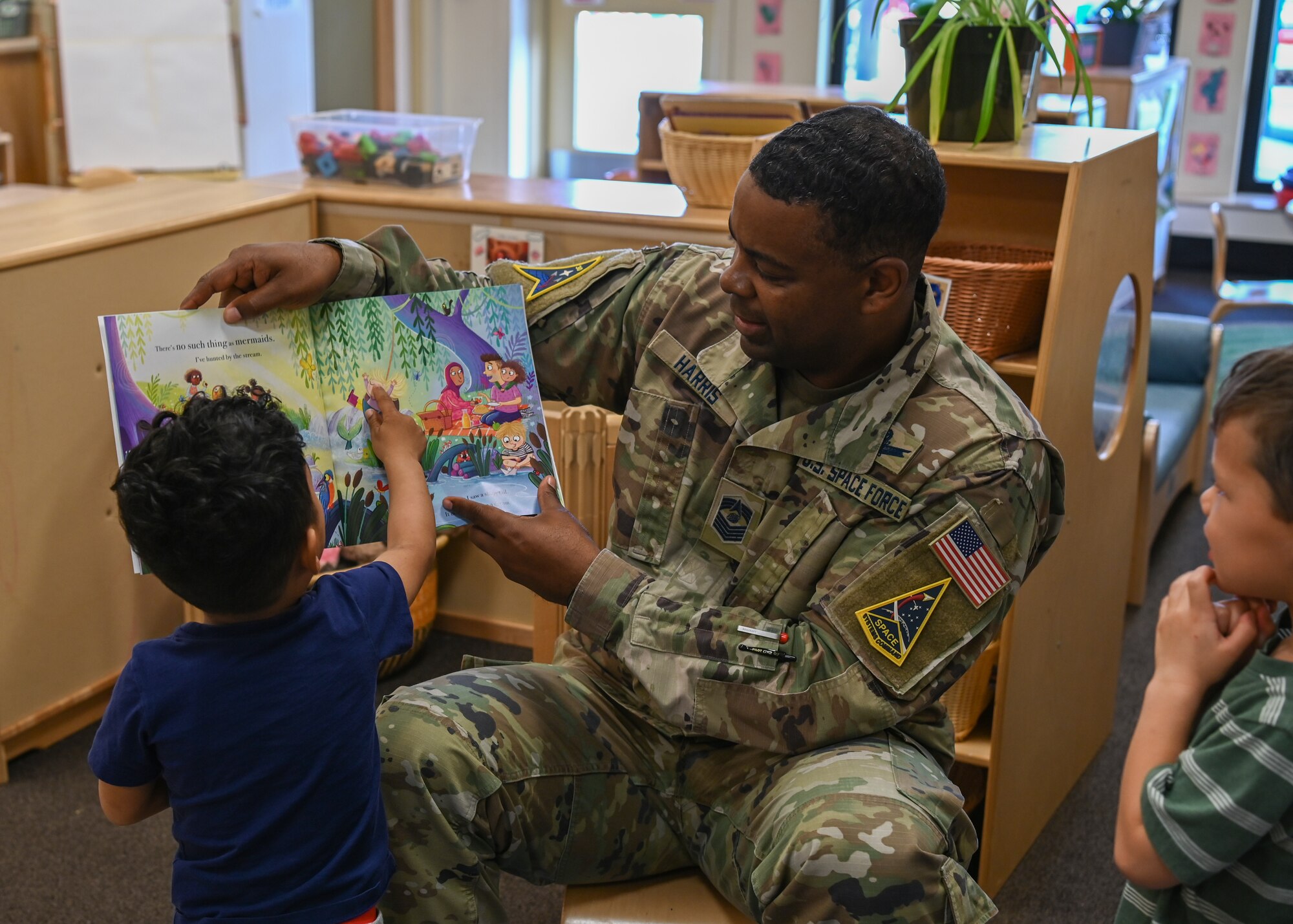 Space Launch Delta 30 senior enlisted leader, reads a story to children at the Child Development Center on Vandenberg Space Force Base.