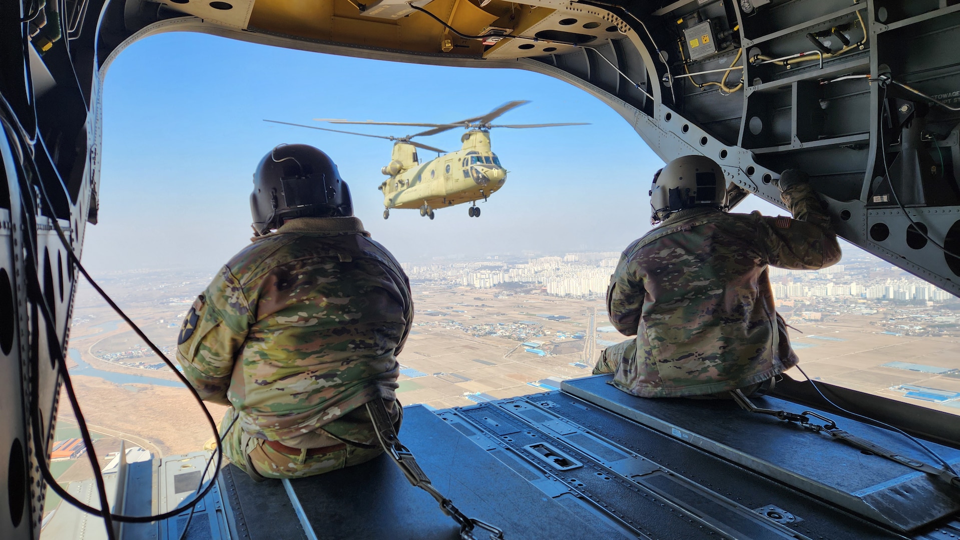 U.S. Army Sergeants Qadiyr Ajala and Dustin Spivey assigned to Bravo Company, 3rd General Support Aviation, 2nd Combat Aviation Battalion, 2nd Infantry Division, ROK-US Combined Division operate as crew chiefs for a U.S. Army CH-47 Chinook during an air assault training event as part of exercise Freedom Shield 24, in South Korea, March 13, 2024. In support of the Armistice Agreement, FS24 underscores the enduring military partnership between the ROK and the U.S. It reinforces the role of the alliance as the linchpin for regional peace and security, reaffirming the unwavering commitment of the U.S. to help defend the Republic of Korea. (Texas Army National Guard photo by Sgt. 1st Class Bethany Anderson 100th Mobile Public Affairs Detachment)