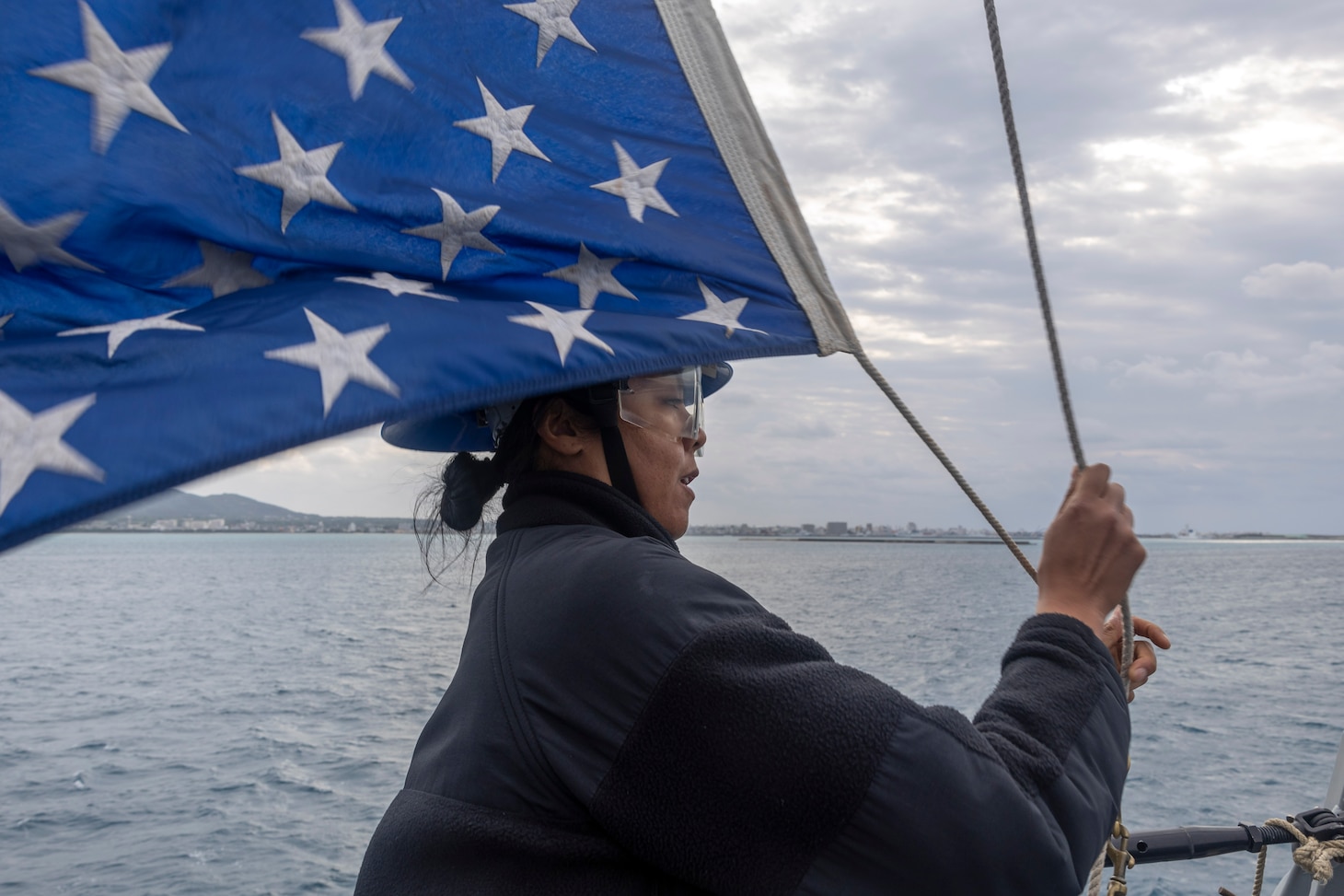 ISHIGAKI, Japan (Mar. 11, 2024) Boatswain’s Mate 3rd Class Kaitlyn Alfaro hoists the Union Jack during Sea and Anchor detail aboard the Arleigh Burke-class guided-missile destroyer USS Rafael Peralta (DDG 115) upon arrival to Ishigaki, Japan for a regularly scheduled port visit. Rafael Peralta is the first United States destroyer to visit Ishigaki. Rafael Peralta is forward-deployed and assigned to Destroyer Squadron (DESRON) 15, the Navy’s largest DESRON and the U.S. 7th Fleet’s principal surface force. (U.S. Navy photo by Mass Communication Specialist 1st Class Devin Monroe)