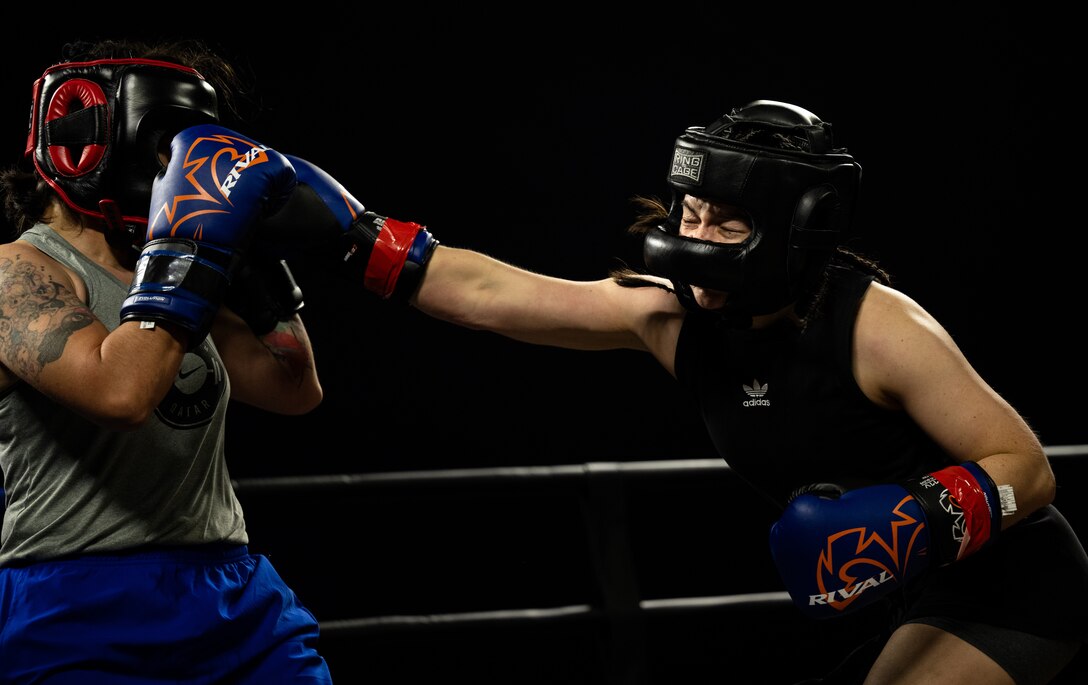 U.S. Air Force Senior Airman Lian Espinoza, assigned to the 379th Expeditionary Force Support Squadron, delivers a blow to her opponent