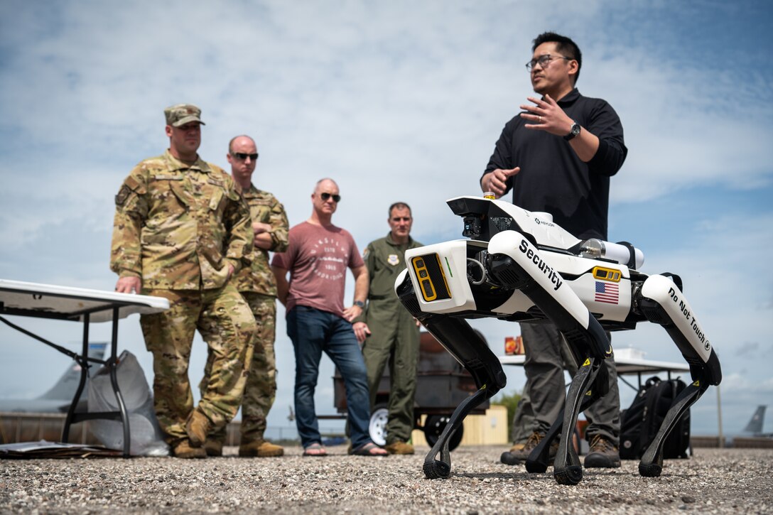 An Asylon representative leads a robotic dog capabilities demonstration