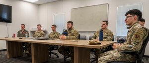 Airmen sit around a table