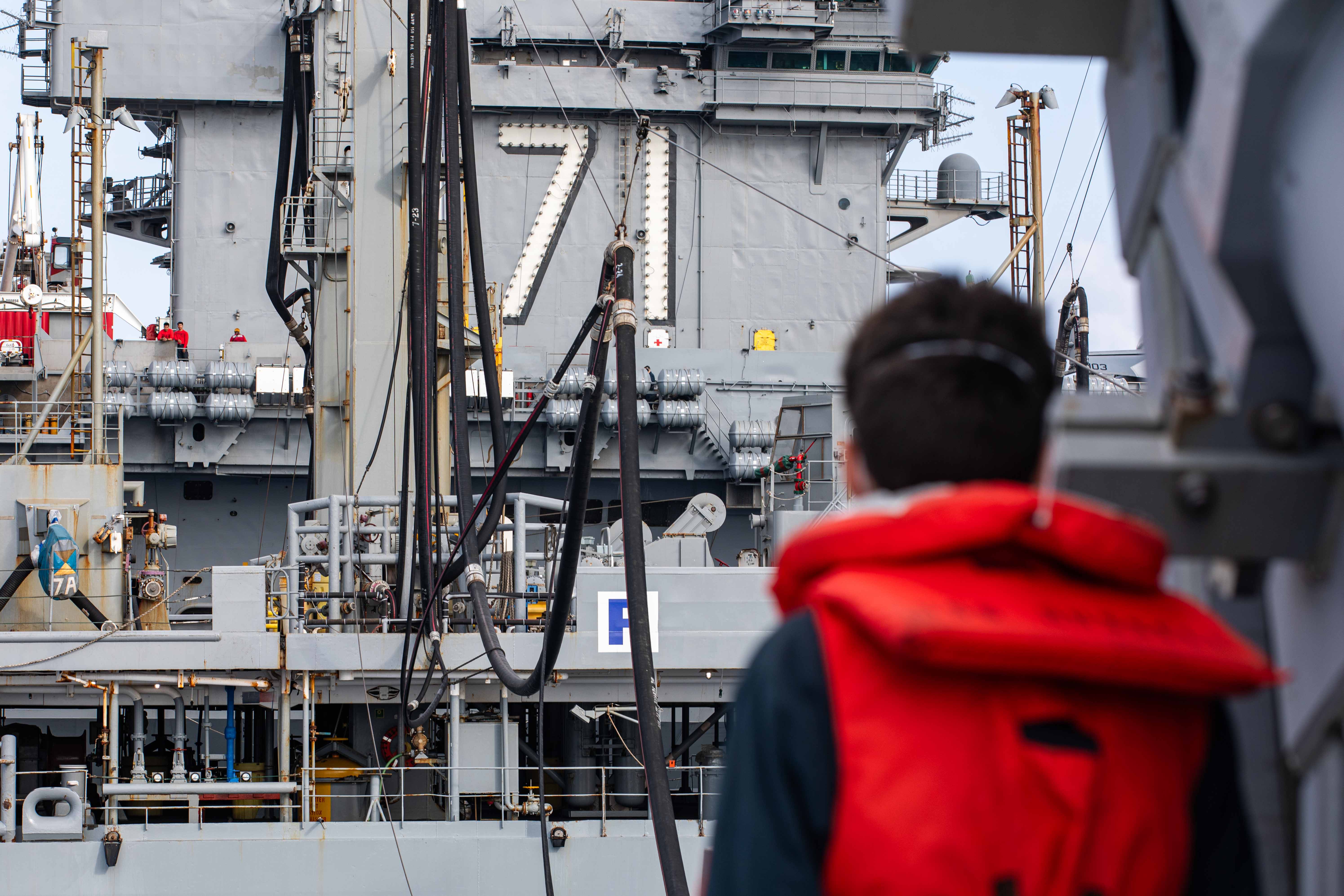 The Arleigh Burke-class guided-missile destroyer USS Russell (DDG 59) receives fuel from the Military Sealift Command fleet replenishment oiler USNS Yukon (T-AO 202), center, while the Nimitz-class aircraft carrier USS Theodore Roosevelt (CVN 71) sails alongside