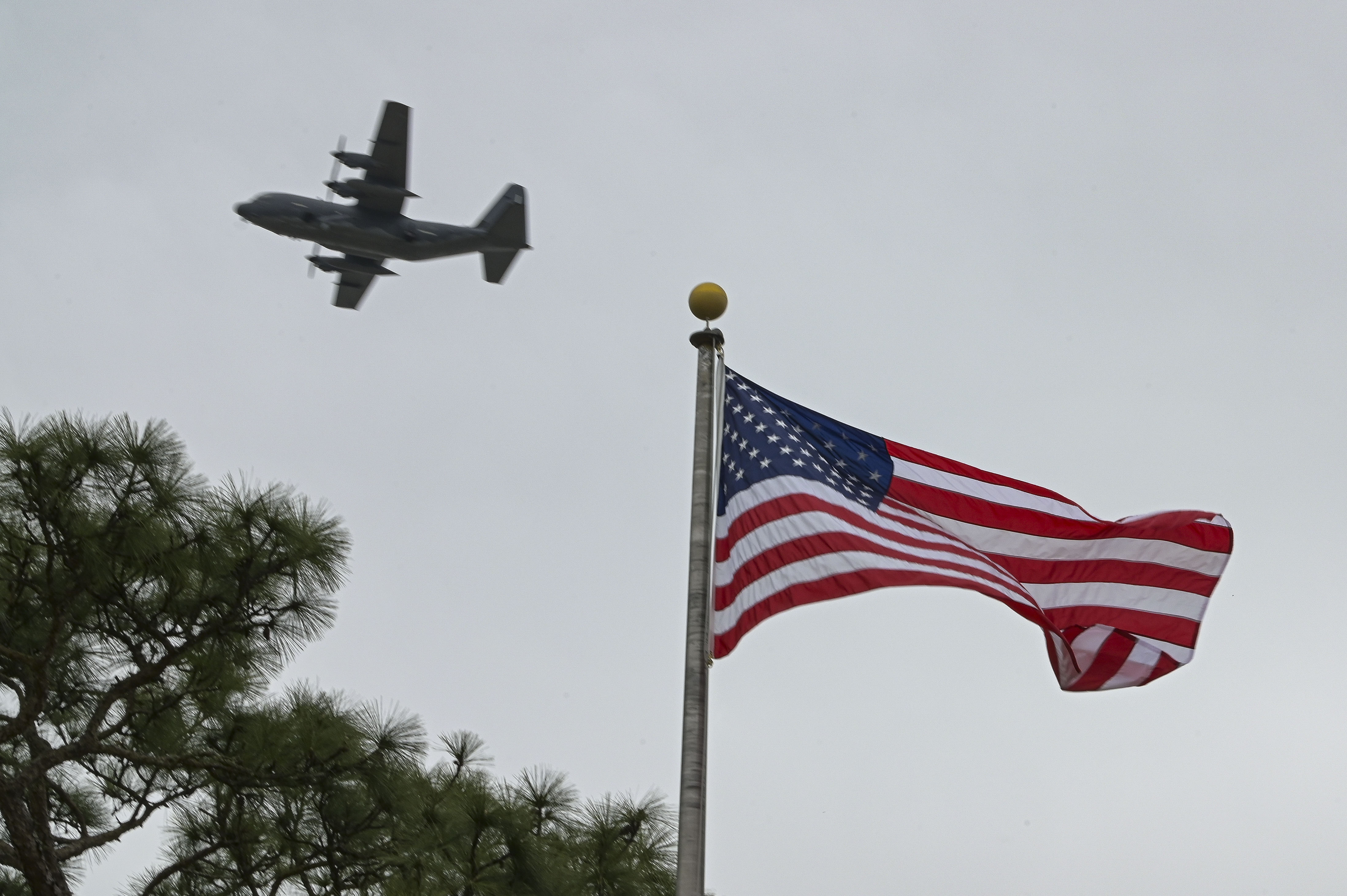An AC-130J Ghostrider gunship assigned to the 16th Special Operations Squadron flies over the Air Park during the Jockey-14 Remembrance Ceremony at Hurlburt Field, Florida, Mar. 14, 2024.
