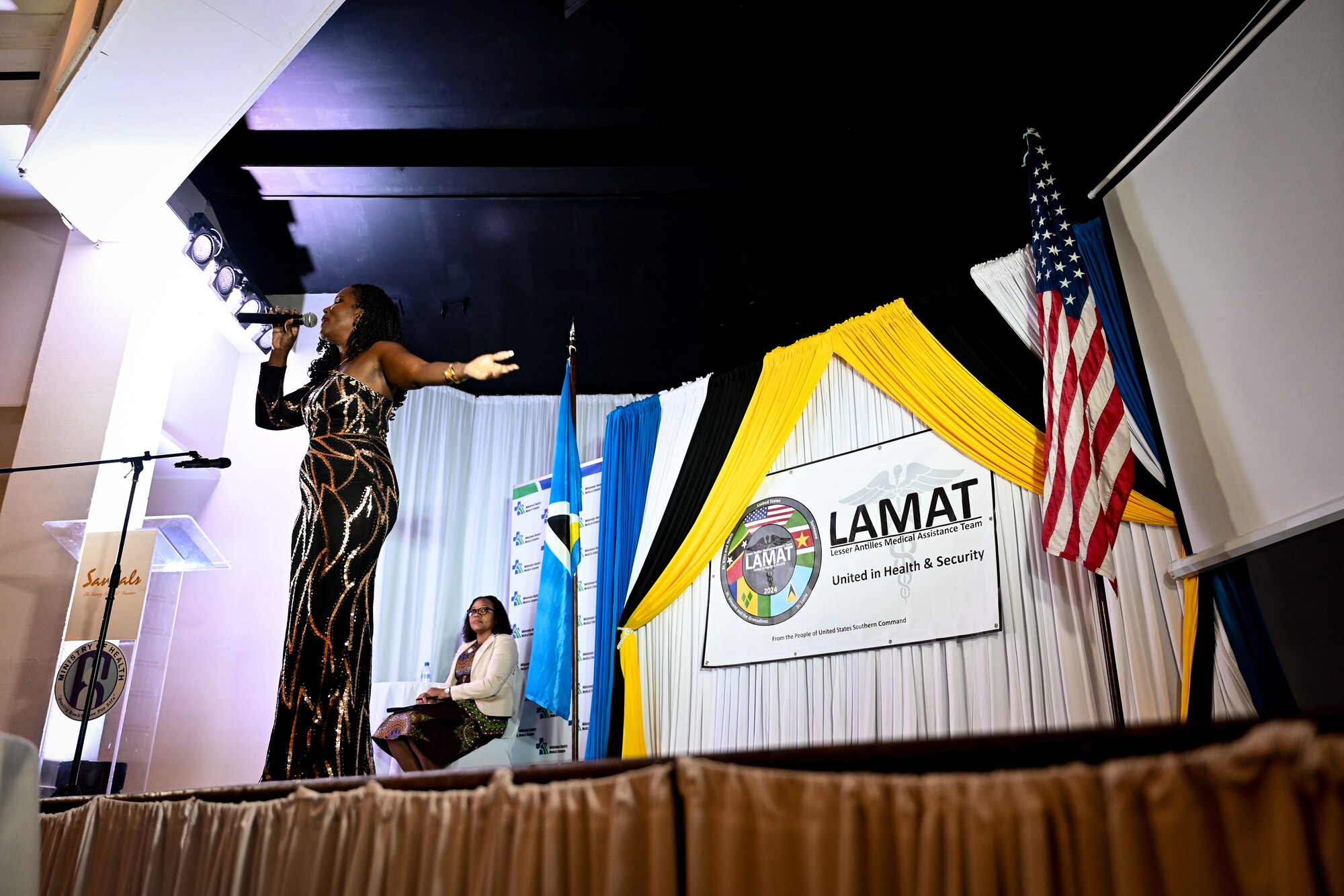 An Owen King European Union Hospital member sings a song during the closing ceremony for the Lesser Antilles Medical Assistance Team mission  in Castries, St. Lucia, March 6, 2024. The LAMAT mission is meant as an opportunity to provide mutual benefits to both the U.S. and St. Lucia through participation in health engagements, knowledge exchanges, and relationship-building. (U.S. Air Force photo by Staff Sgt. Madeline Herzog)
