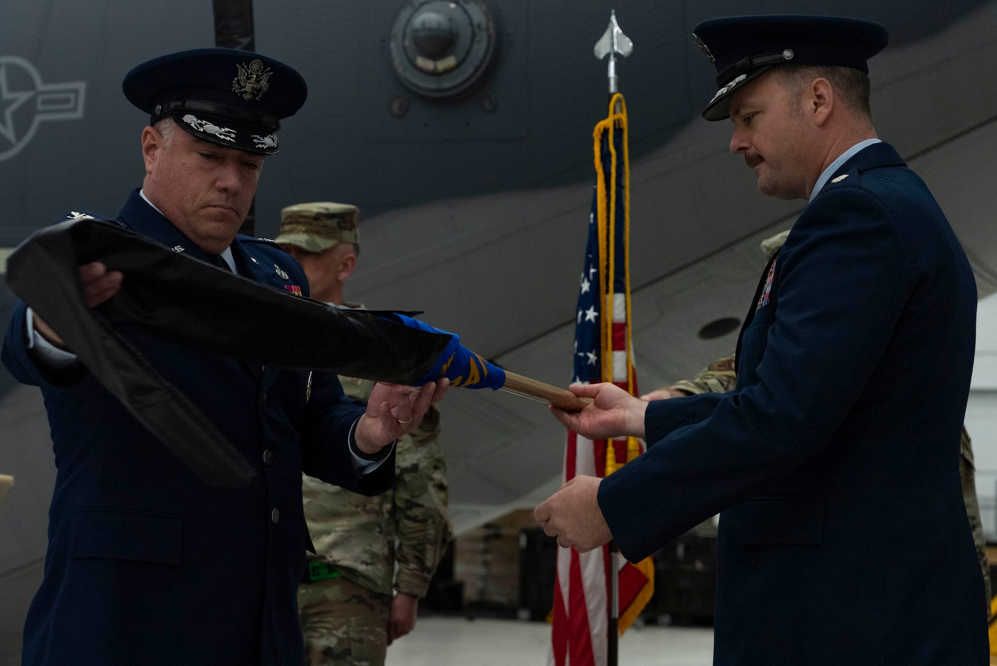 U.S. Air Force Col. Harry Seibert, 27th Special Operation Maintenance Group commander, left, and Lt. Col. Sean Allen, 16th Special Operations Aircraft Maintenance Squadron commander, right, uncase the new guidon of the redesignated 16th SOAMXS during a ceremony at Cannon Air Force Base, N.M., March 15, 2024. The redesignation was enacted to better align the unit with its identity and mission: to develop elite maintainers ready to generate safe, reliable aircraft to execute special operations missions. (U.S. Air Force photo by Staff Sgt. Nicholas Swift)
