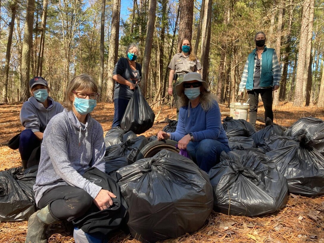 Volunteers with Park Ranger posing with trash that was collected during a litter pick up at Hogan Creek Wildlife Management Area.