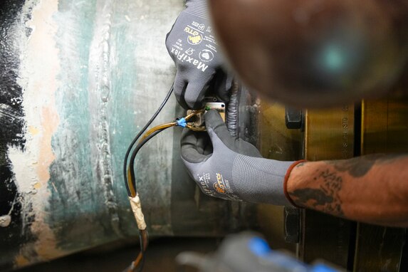 A technician in support of Joint Task Force-Red Hill (JTF-RH) conducts phased array ultrasonic testing to validate the welding integrity on pipelines disconnecting the Underground Pumphouse from the Red Hill Bulk Fuel Storage Facility (RHBFSF), Halawa, Hawaii, March 13, 2024.