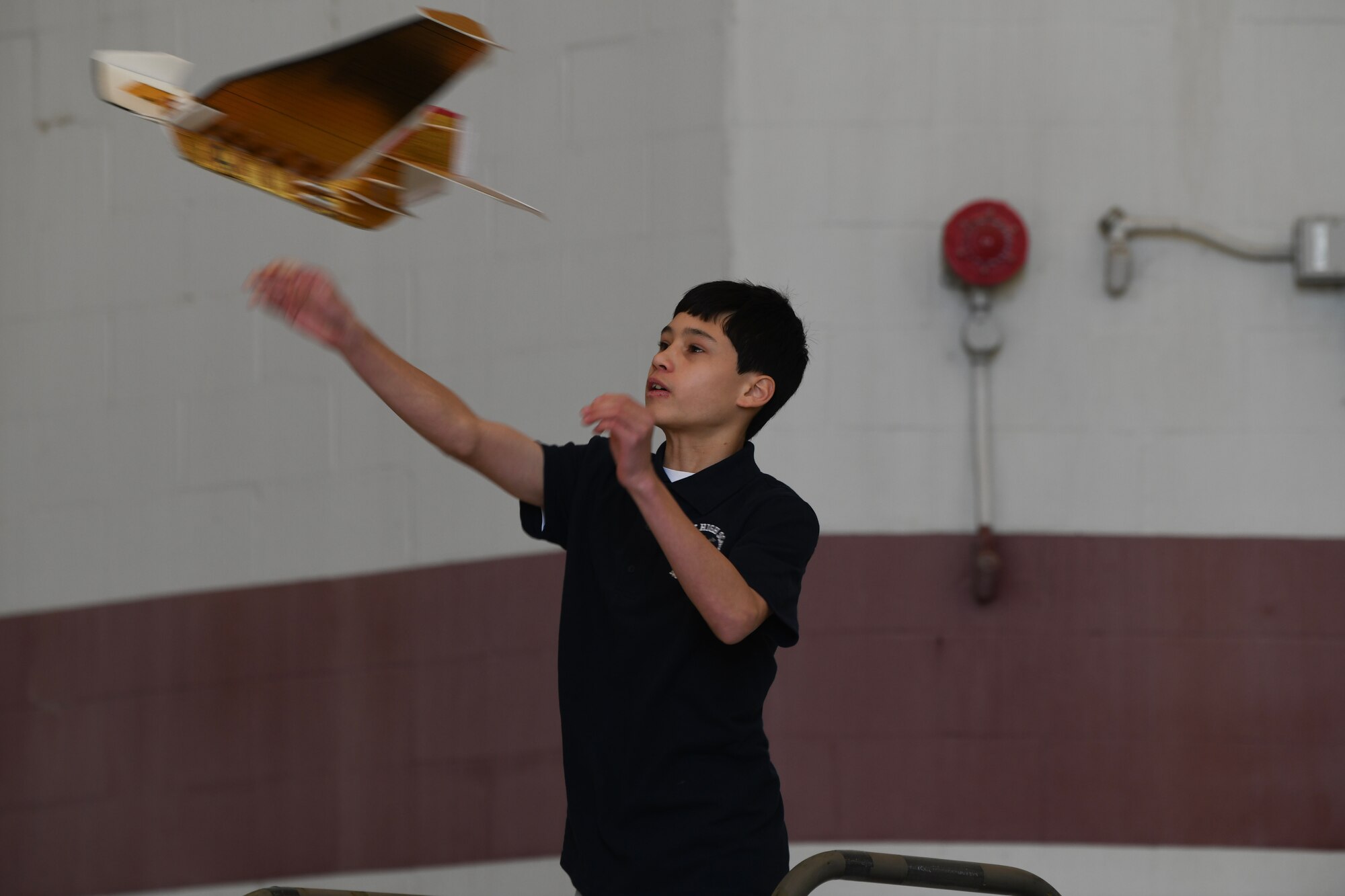 Student throws glider