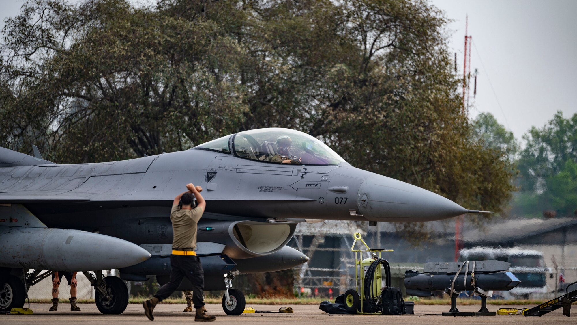 Senior Airman Thomas Purdy, 80th Fighter Generation Squadron dedicated crew chief, marshals an F-16 Fighting Falcon for a routine flight